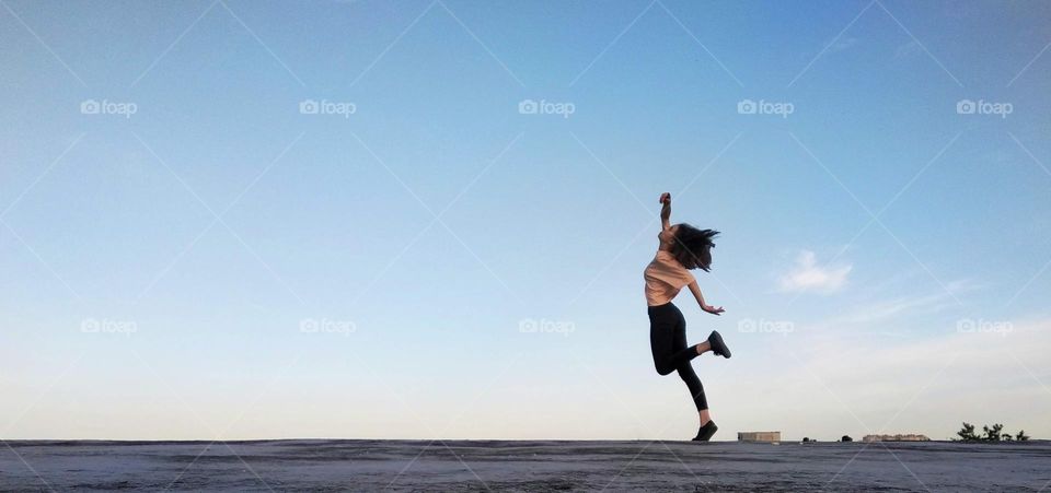Running woman on sky background