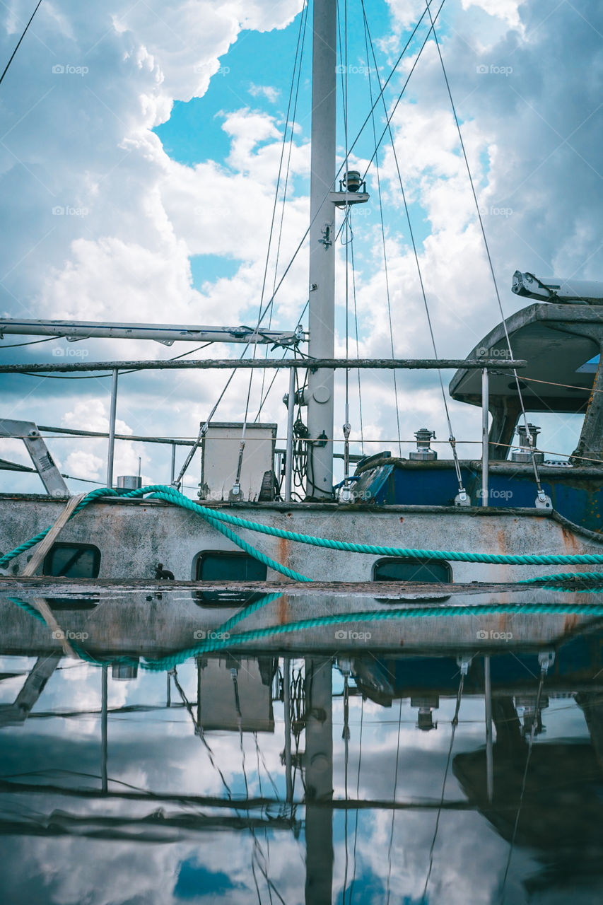 Reflection of a boat in a puddle