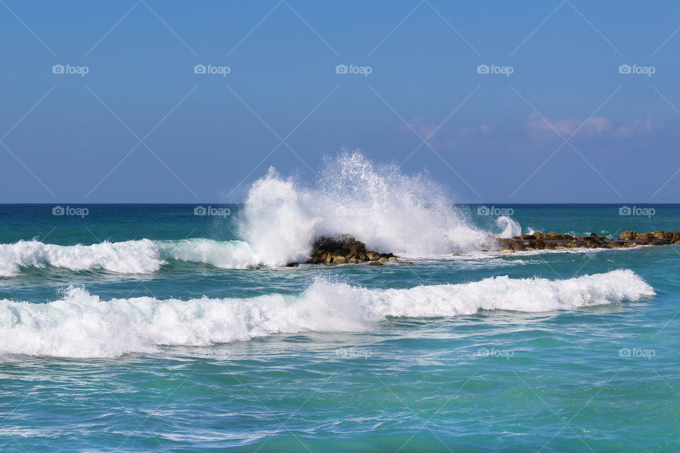 Rocky coastline in Mediterranean sea. Rocks through the water.