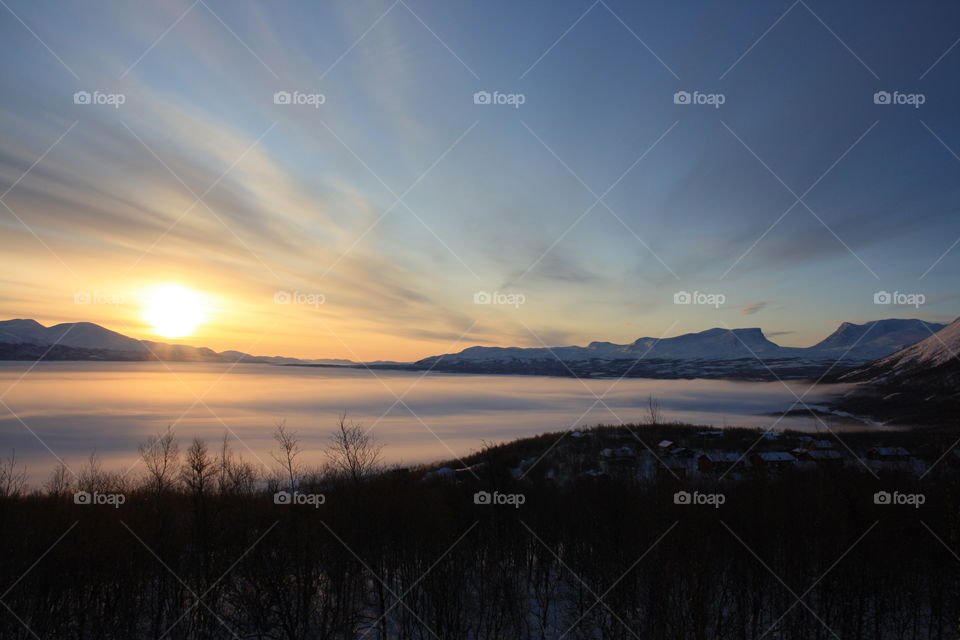 Clouds over lake during misty morning