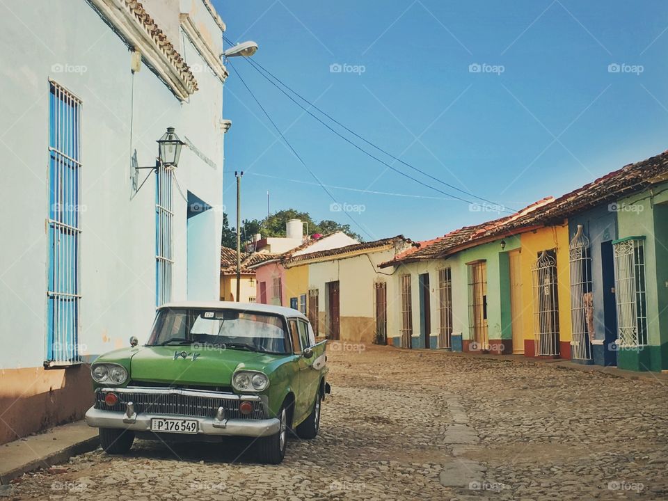 Time traveling in Trinidad, Cuba. River stone streets, colorful facades, and classic cars everywhere you look.