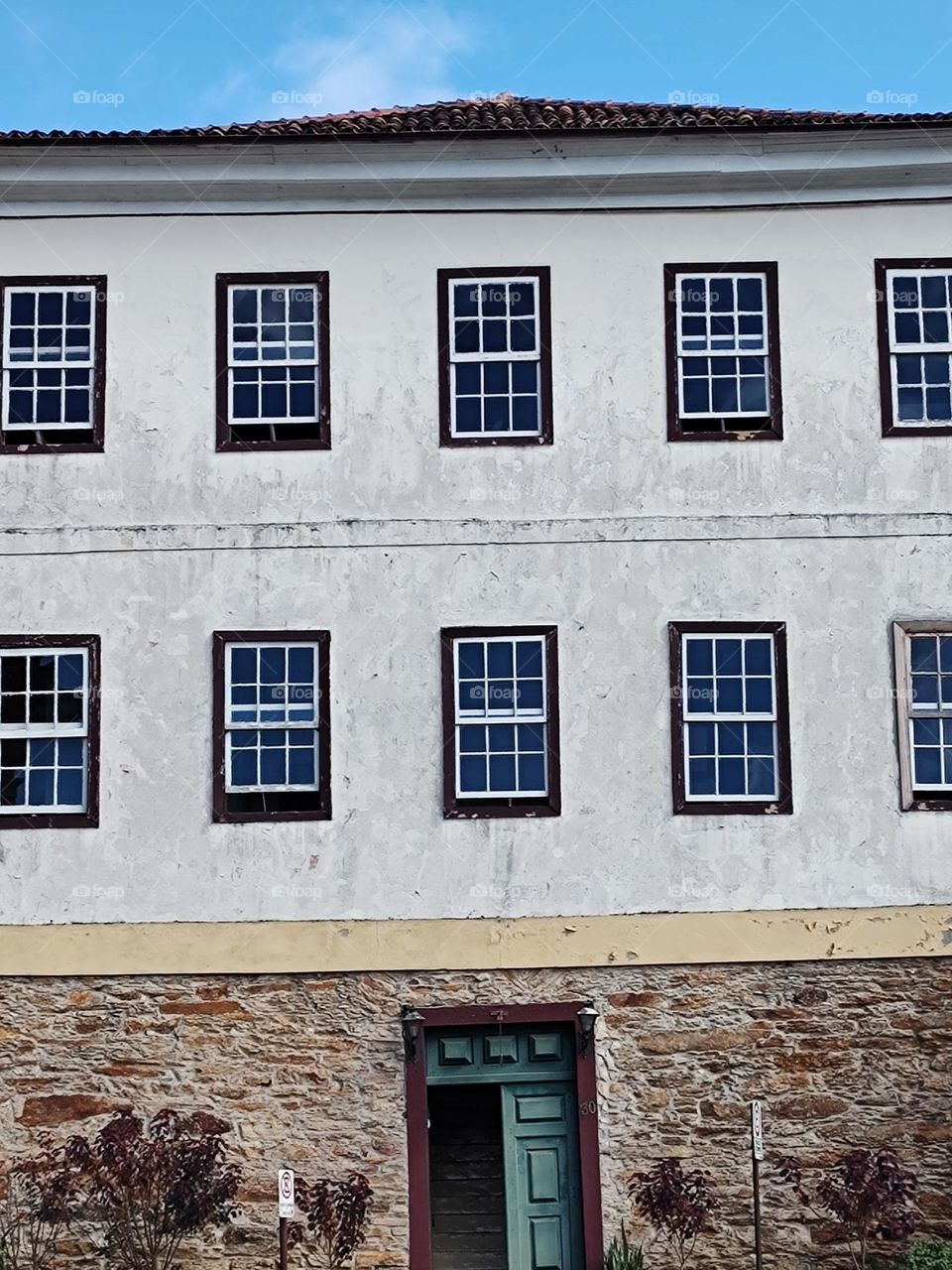 old mansion, with several wooden windows.