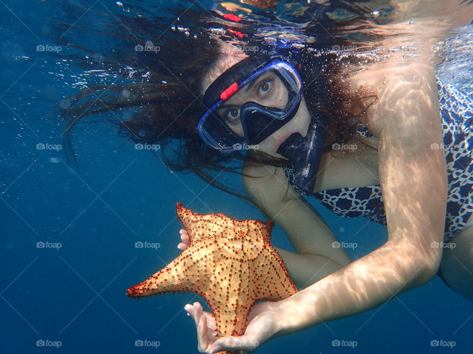 Woman with starfish in underwater