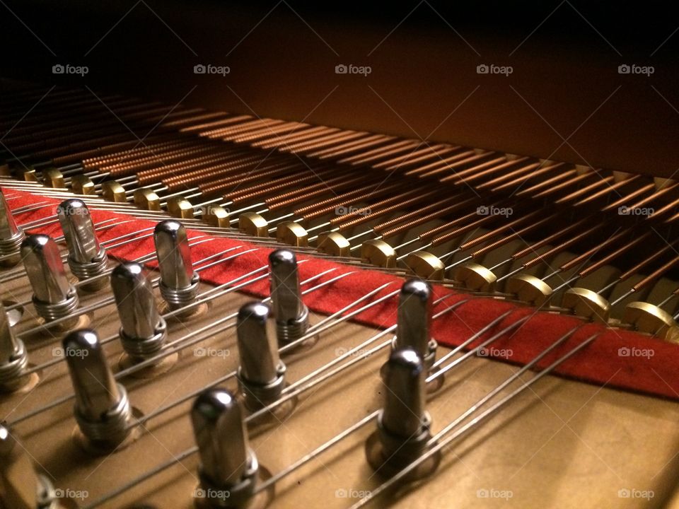 The heart of an instrument. Piano strings inside a grand piano awaiting the touch of a musician’s hand. 