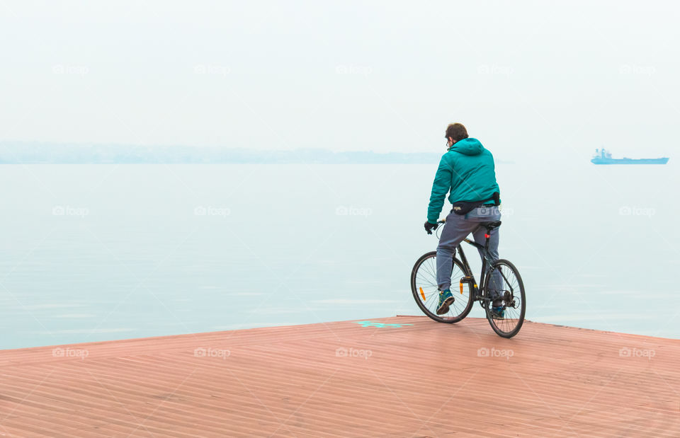 Young Man On Bike Ride On The Quay
