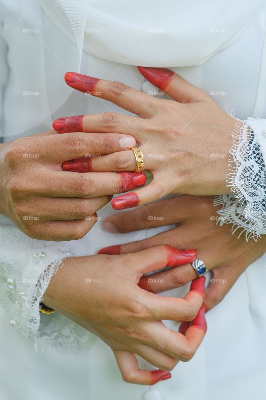 Lovers ring.Hand groom couple lovers putting wear the Wedding Ring on bride Holding hands together.