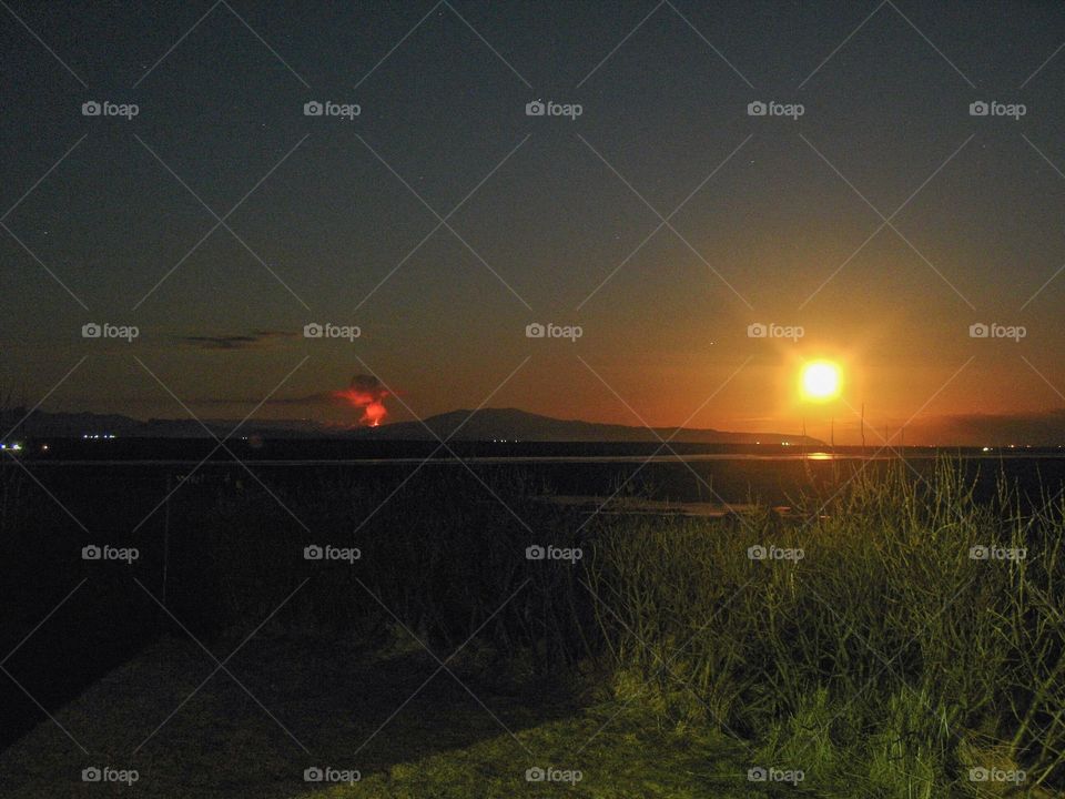 Volcano in the distance signaling day or noght can’t tell.  The time of day is sort of shrouded in the moment.