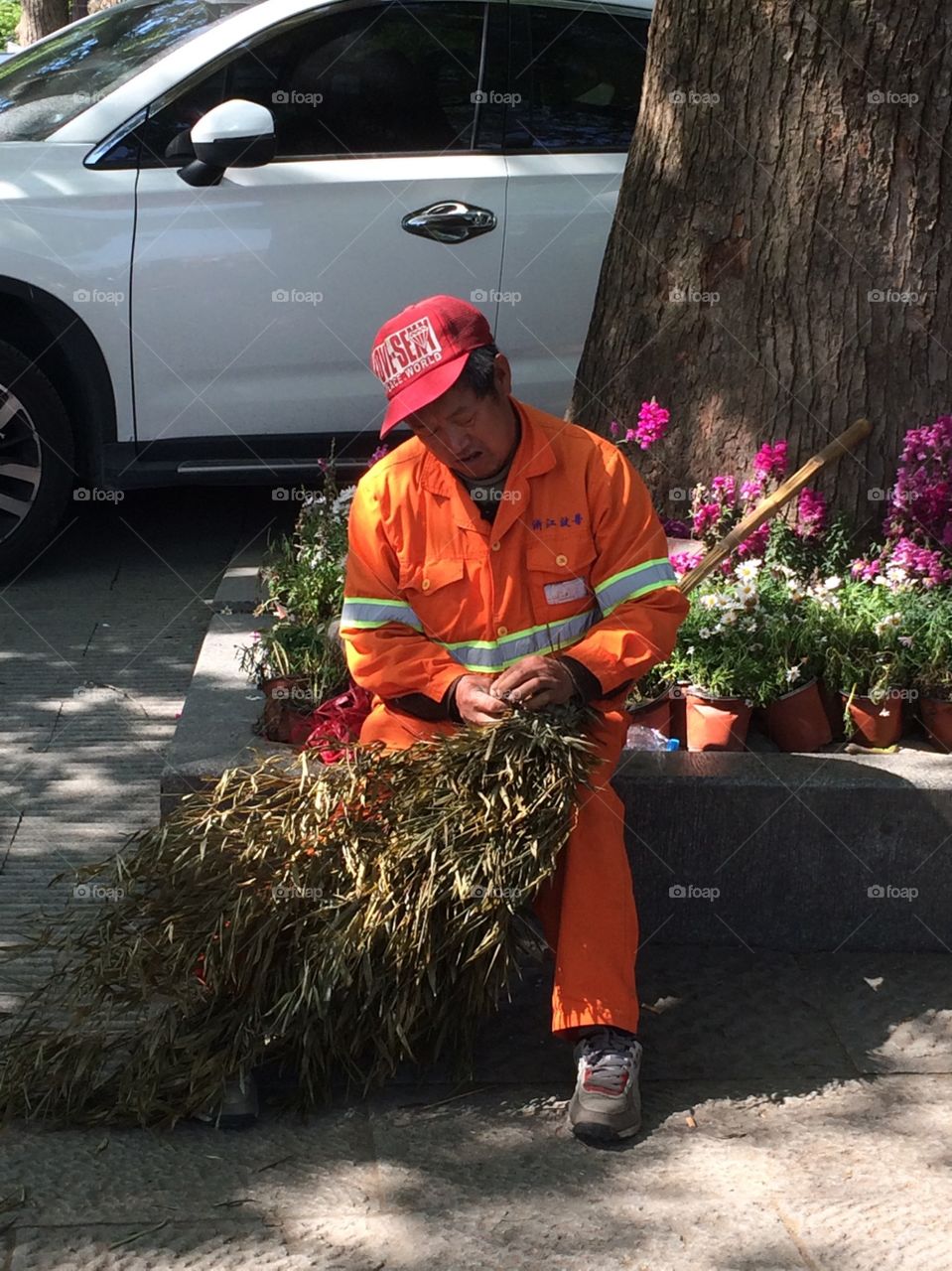 Maintenance man making a rake from bamboo 