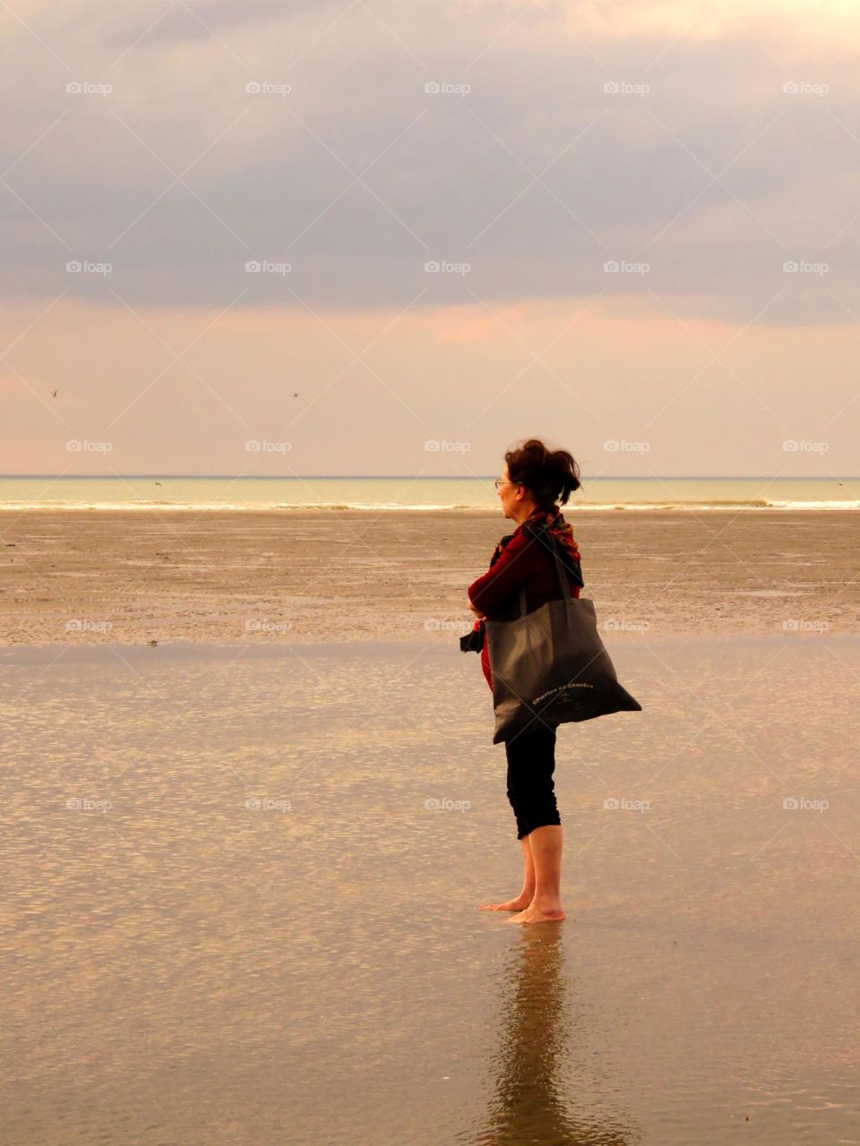 Mature woman standing at beach