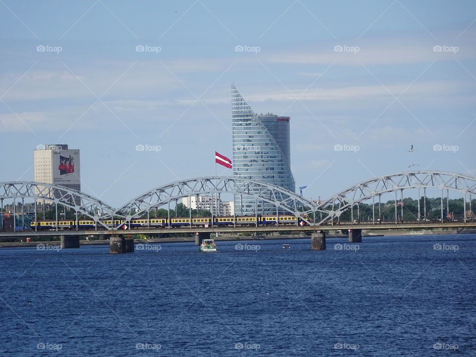 A train on the bridge through Daugava river in Riga city centre in Latvia