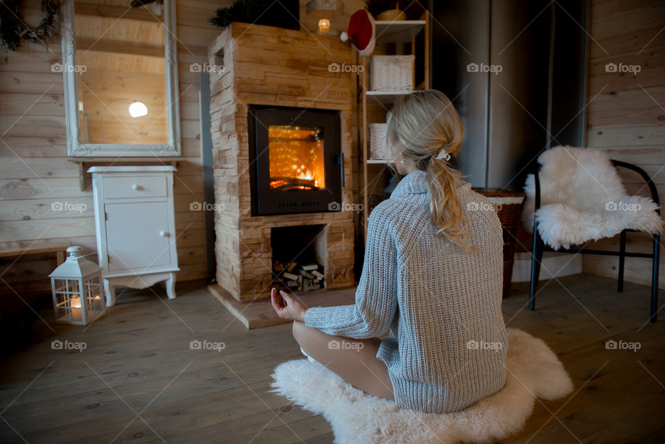 Young woman practicing yoga indoors