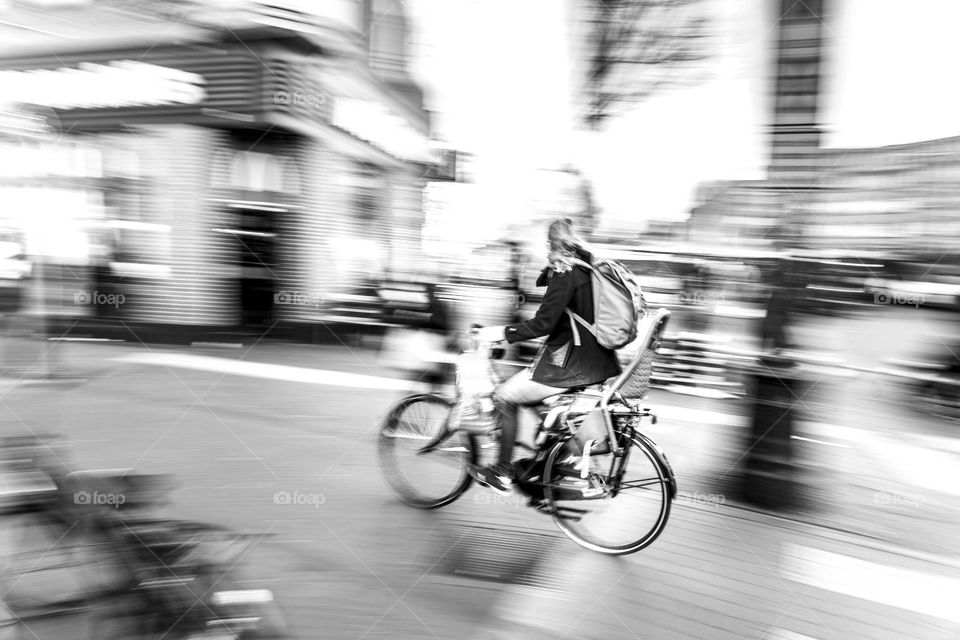 a lady riding a bicycle in slow motion panning effect