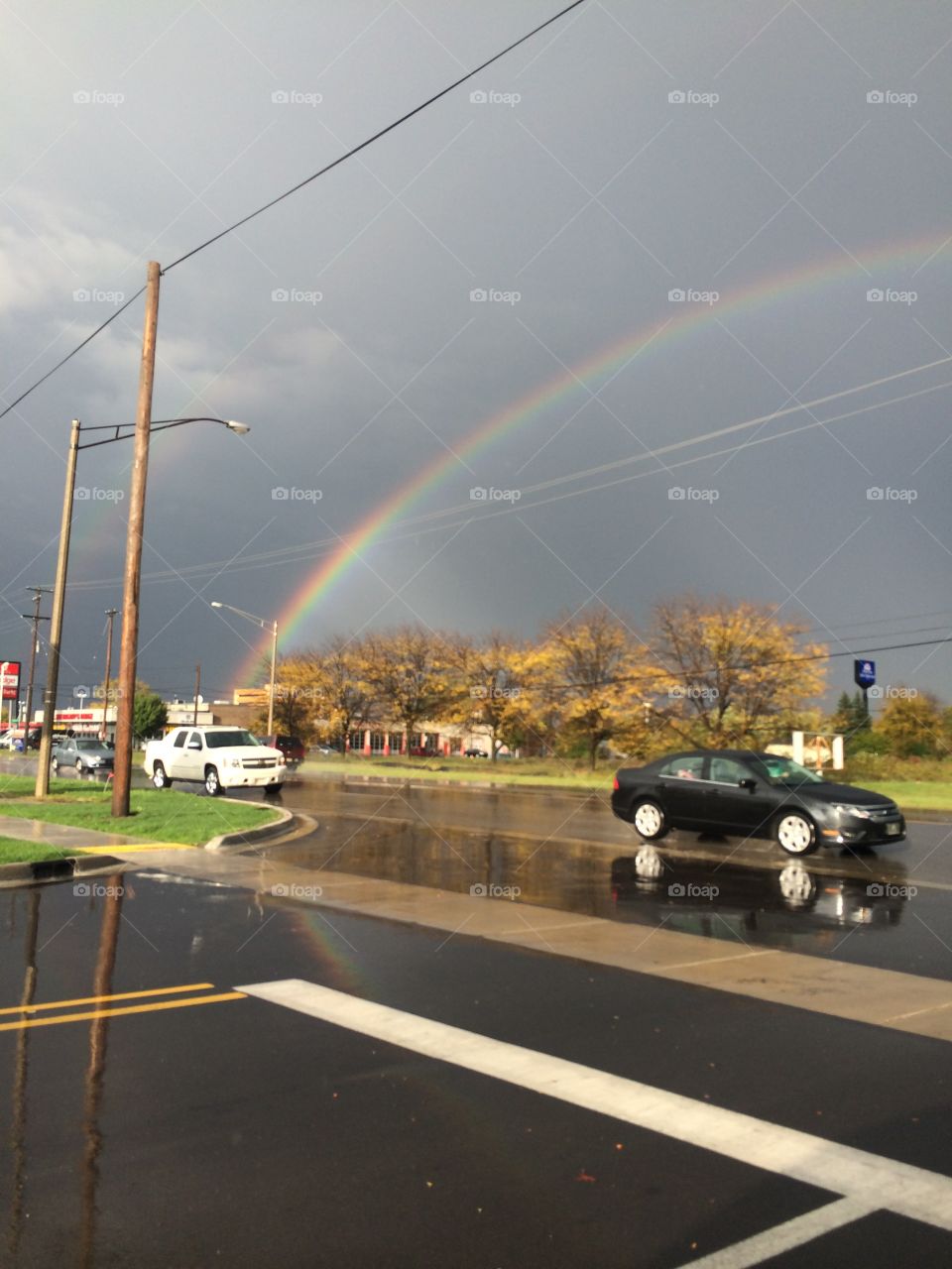 Traffic after a storm with a rainbow
