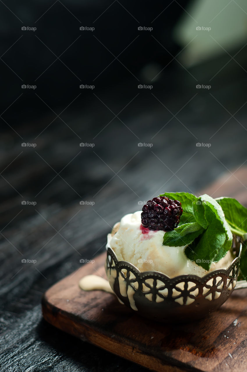 Blackberry on ice cream in bowl