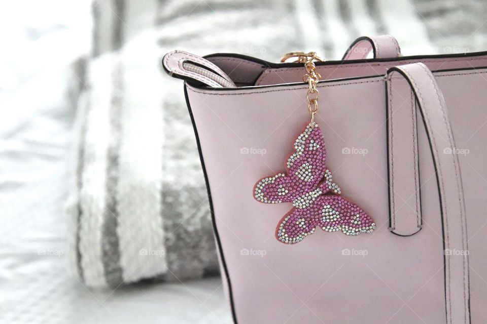 Pastel pink purse with pink butterfly charm