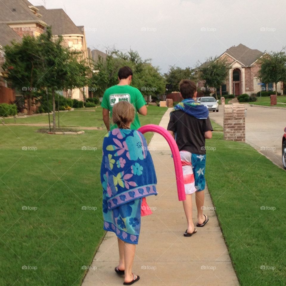 Swim time is over. Kids heading back home from the pool