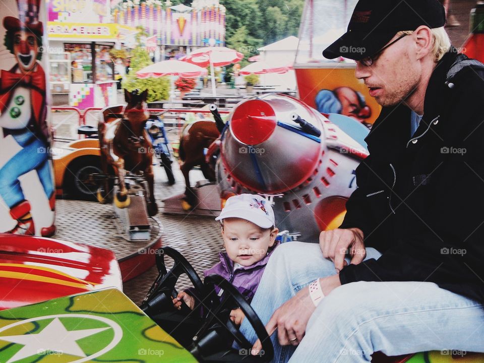 Father and child on the amusement park