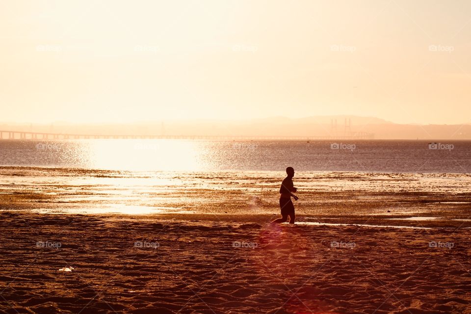 Running in the beach during sunset 