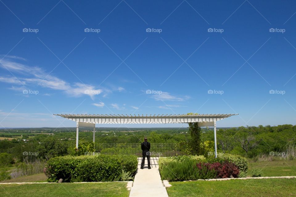 Sharp dressed man in suit. Solitude landscape man in black suit enjoying the view