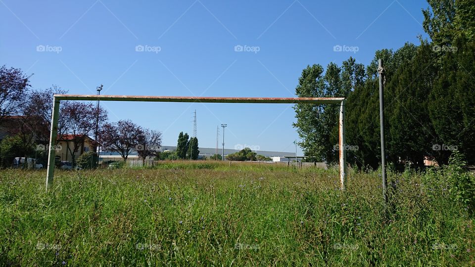 abandoned Italian playground, tall grass