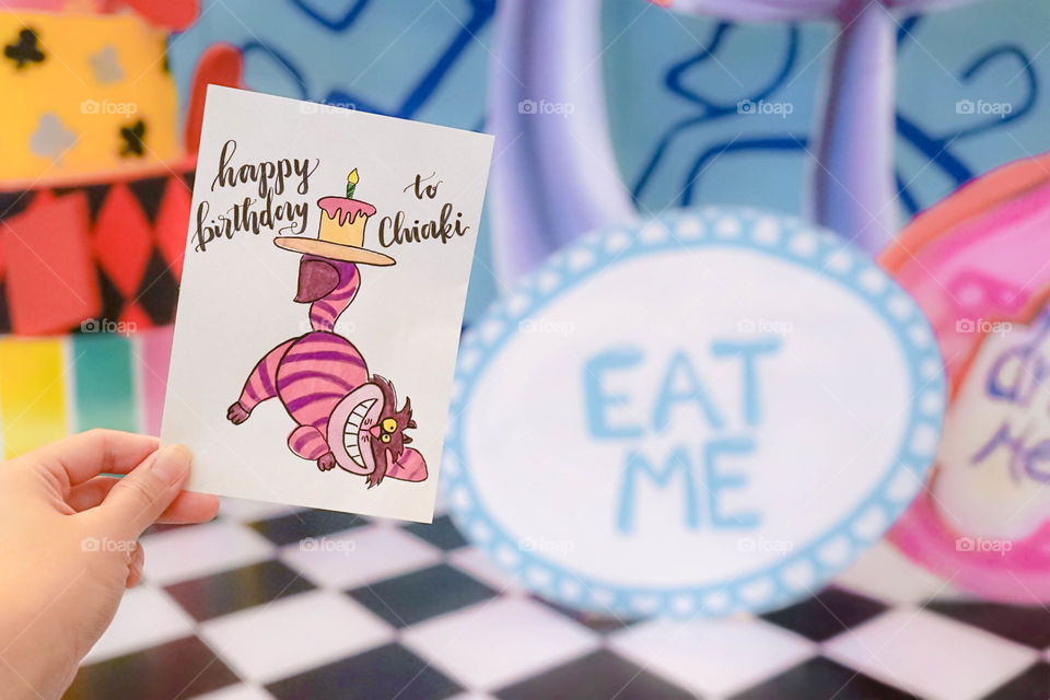 Happy Birthday card and stage props in concept of Alice in Wonderland