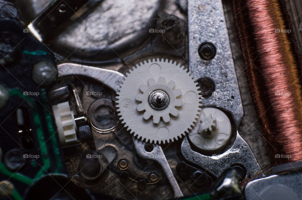 Macro shot of very tiny inner machinery parts of a wrist watch.