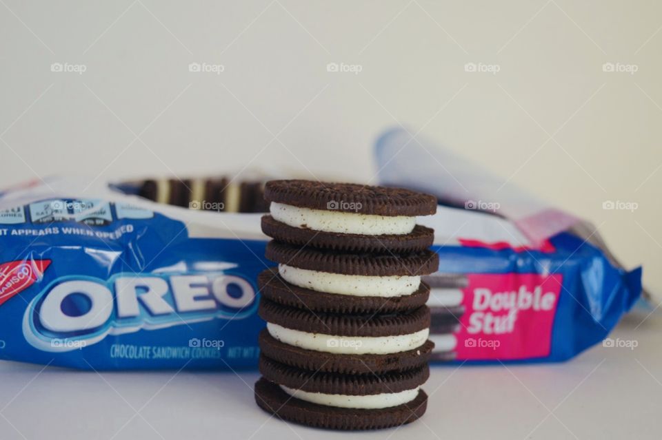 Double Stuf Oreo cookies stacked in front of an open package 