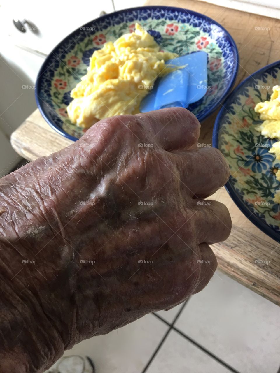 Hand serving scrambled eggs 