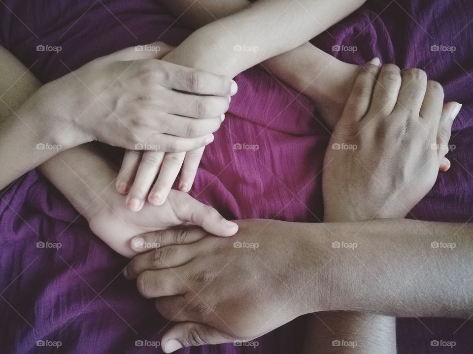 High angle view of holding hands against purple background