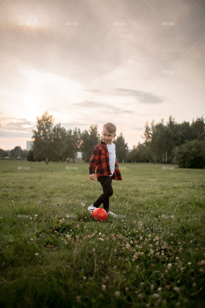 Little boy playing in soccer in a park 