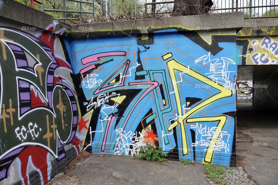 Colorful abstract graffiti and lettering on the wall by the path near Vitkov in Prague, Zizkov.