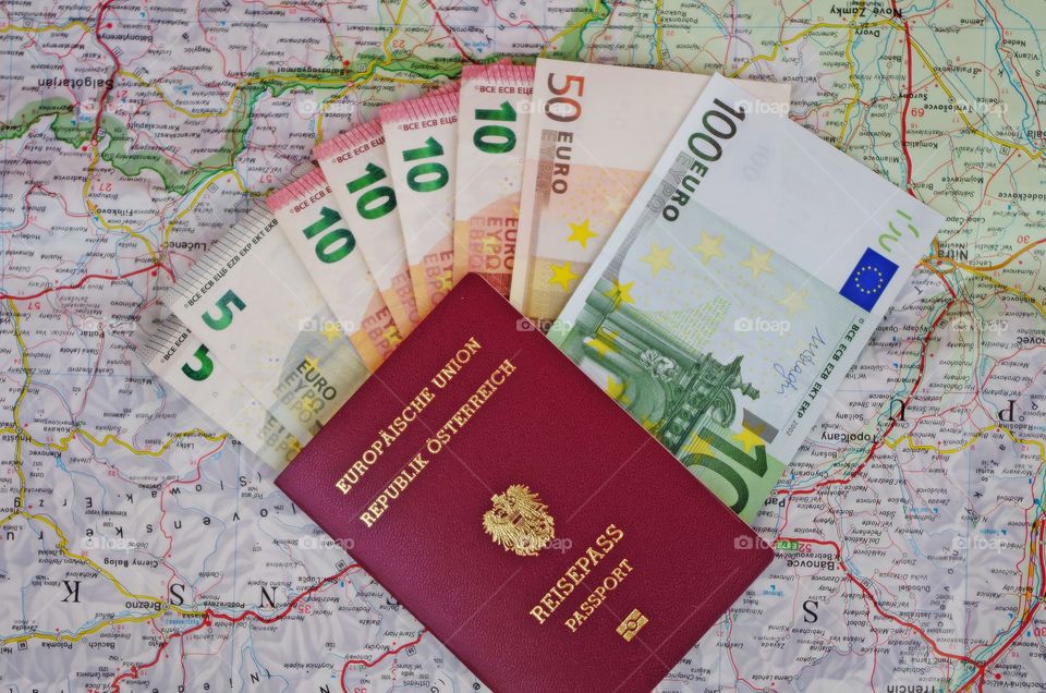 Euro money with passport on map, concept saving money for next trip.
