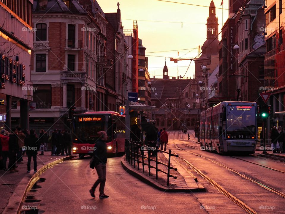 Bus picking up commuters by dusk, Oslo Cathedral in the background