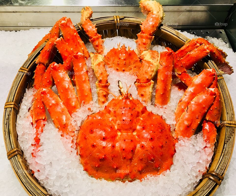 Fresh king crab in the basket with ice seafood gourmet cuisine at fish market in Taipei, Taiwan