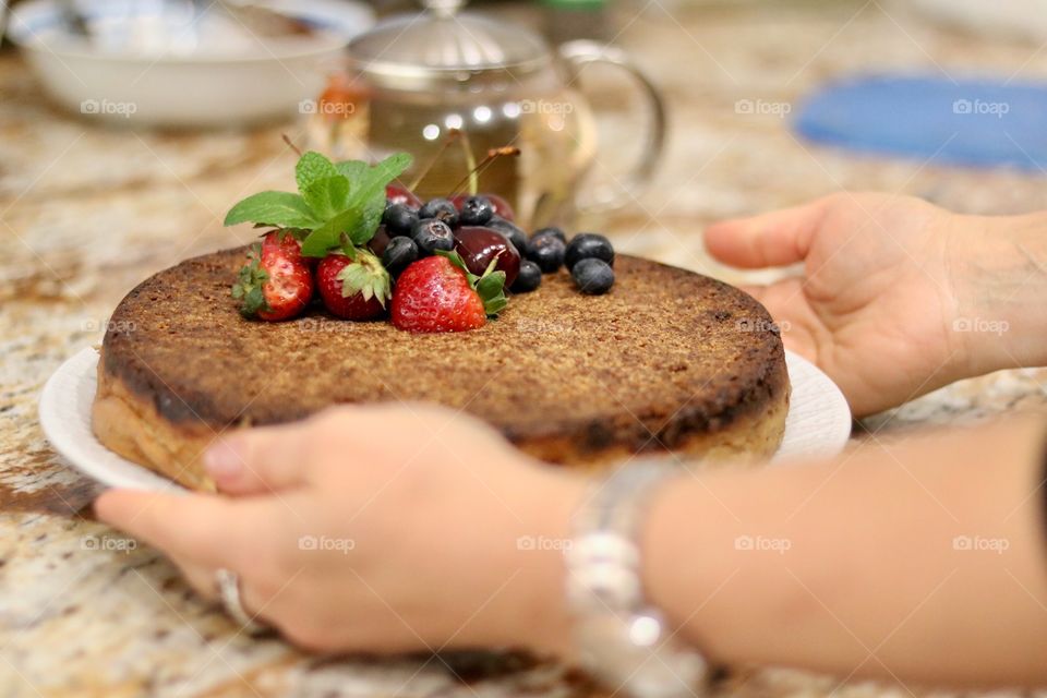 A person holding cake in plate