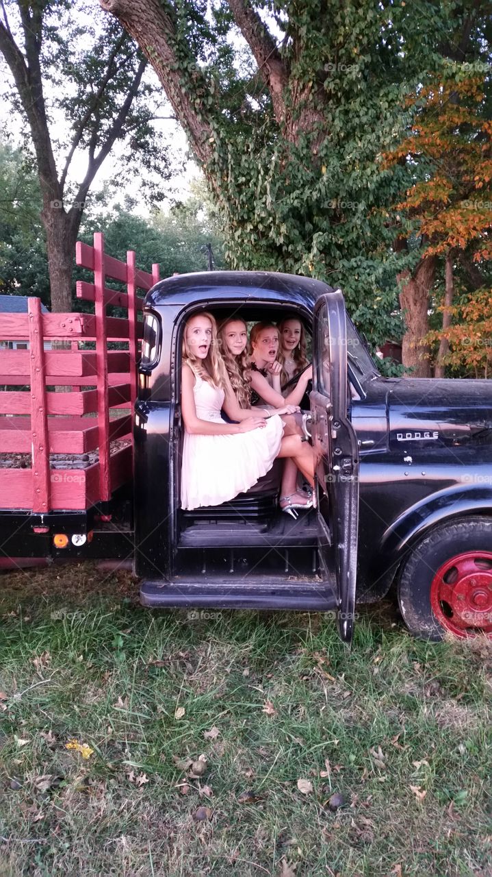 Group of girl sitting in truck