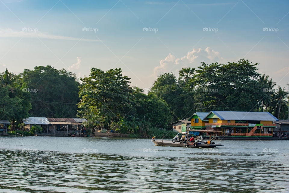 Ship passenger and motorbikes across  Khwae Noi river at Kanchanaburi Thailand.