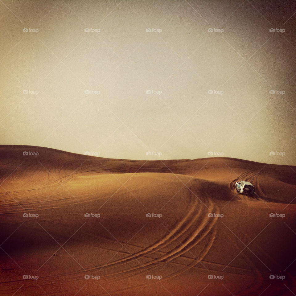 A Toyota LandCruiser bashes the dunes in the desert outside Dubai.