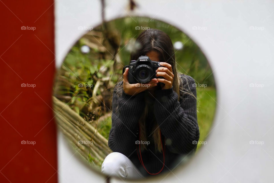 Photographer making a photo in the mirror