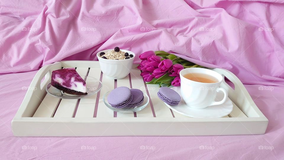 Breakfast in bed💜 Oatmeal, berries, cake, cup of green tea, tulips, macarons💜