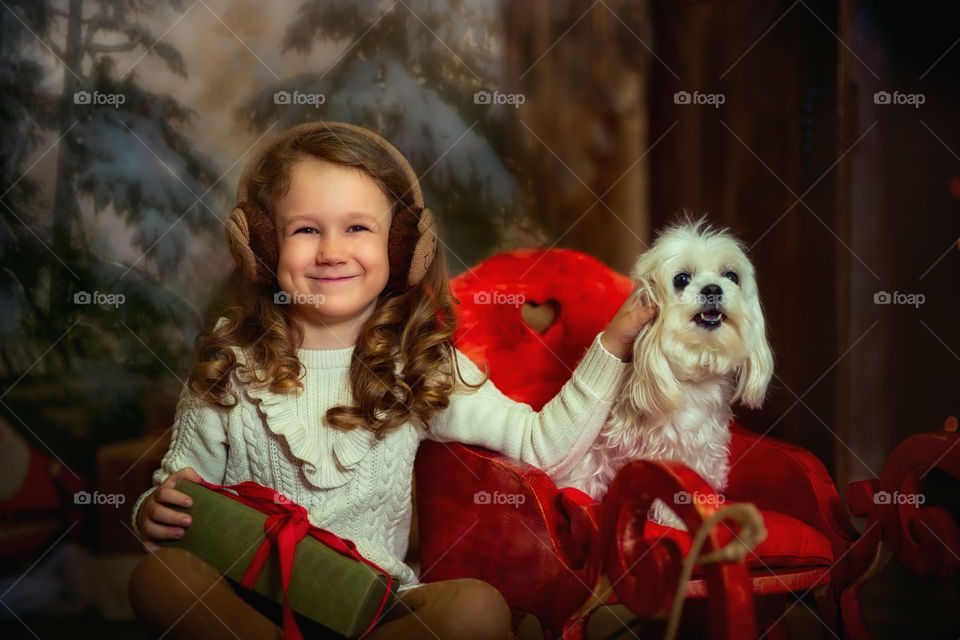 Little girl with Maltese dog at Christmas Eve 