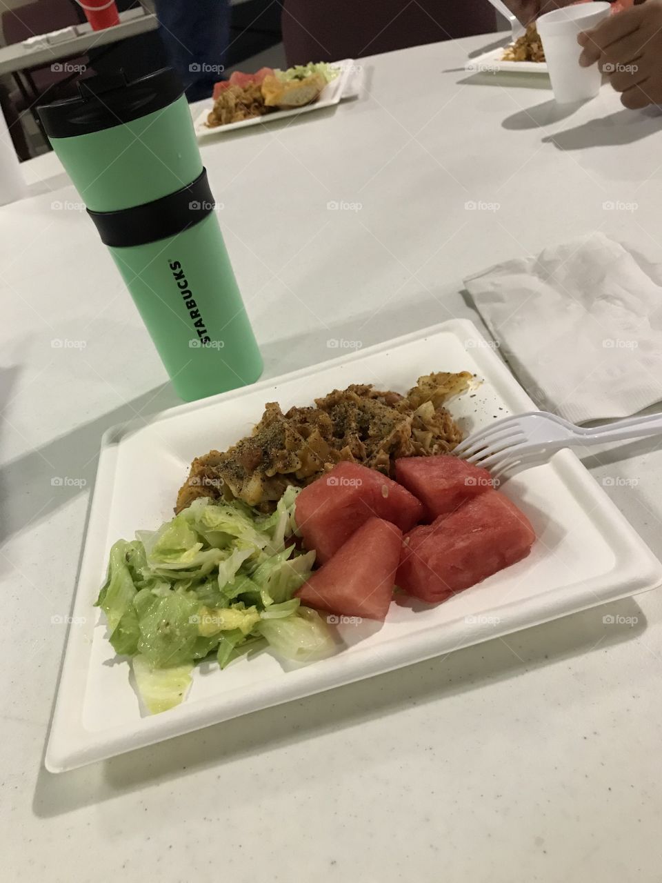 Dinner with water in a coffee cup at church. The evening meal looks good enough to satisfy one’s appetite. Also, the water is good for one’s health.