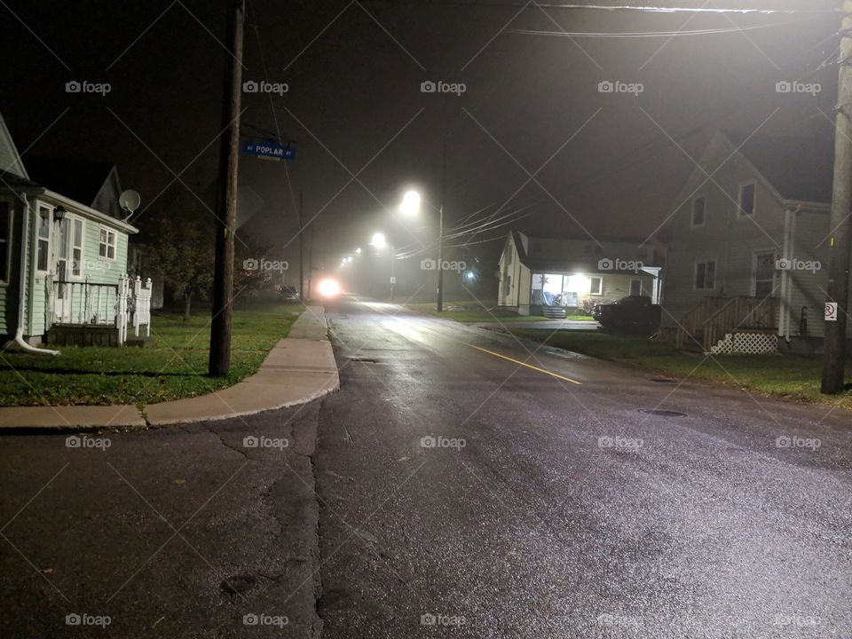 quiet neighborhood street on a rainy night