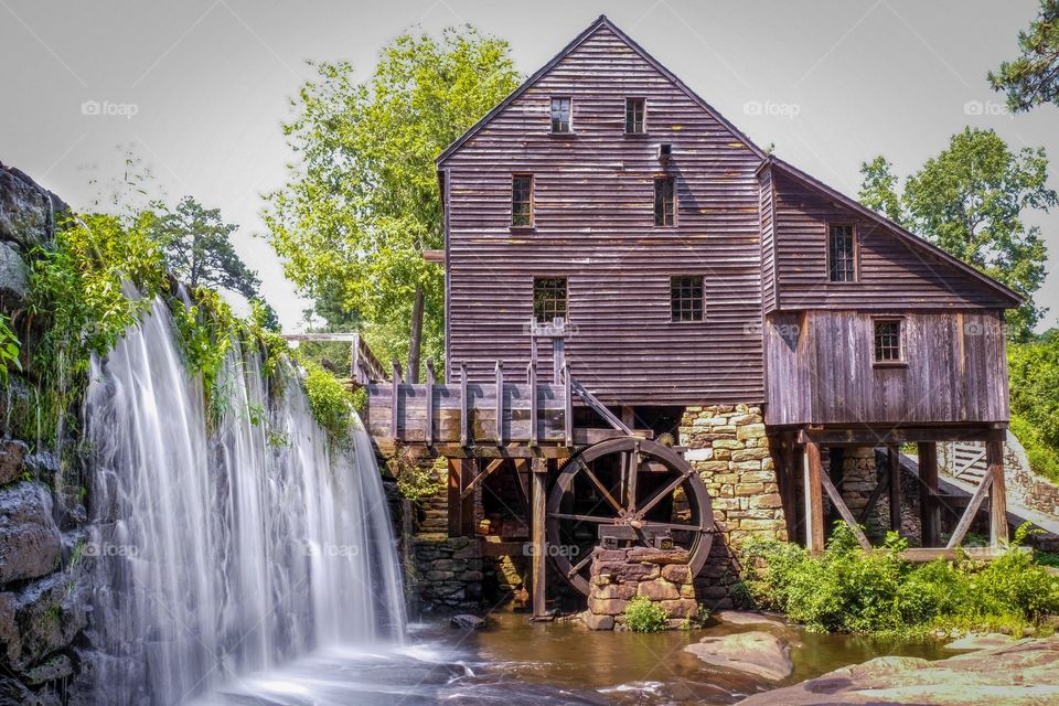 Foap, Color vs Black and White: Summertime at Historic Yates Mill County Park in Raleigh, North Carolina with bright splotches of green around the old gristmill and waterfall. 