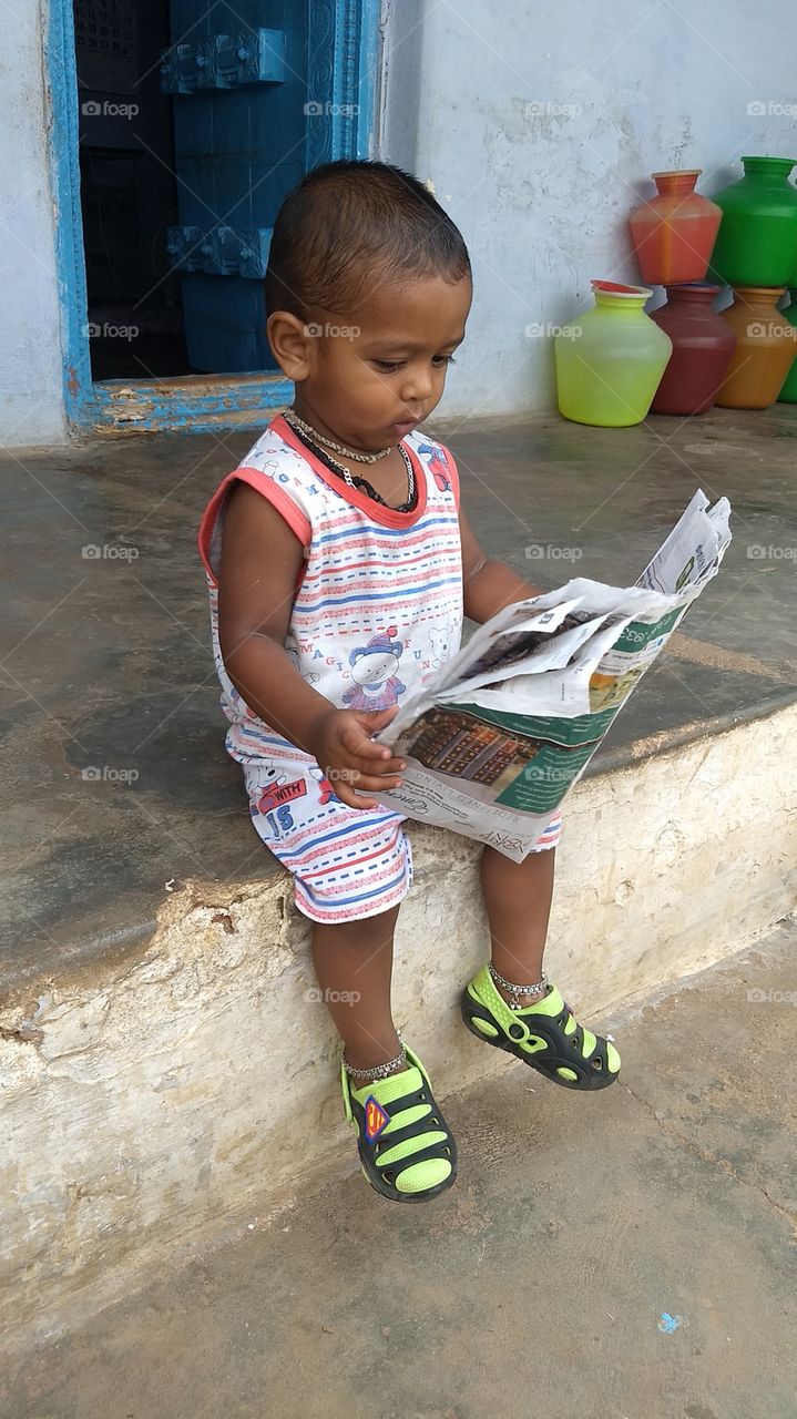 Kid read newspaper