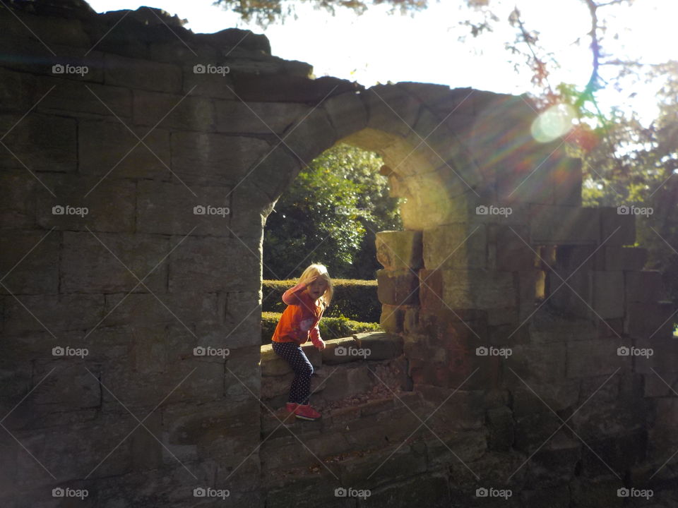 Girl sitting under arch