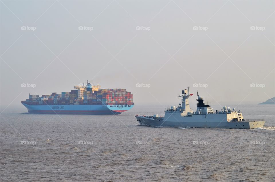 At sea container vessel and warship