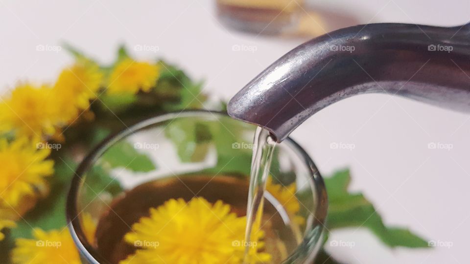 Close-up of teapot pouring tea