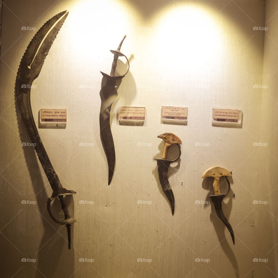 Red Fort Museum of Arms and Weapons, New Delhi, Jul 21, 2018: Arms and Weapons Showcased here in Galleries includes Arrows, Swords, Revolvers, Machine Guns, Shells, Daggers Ivory and Battle Axes.