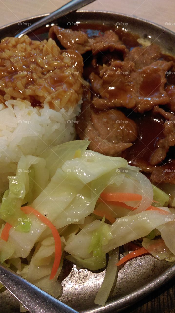 A dish of buta-don, rice topping with fried pork and vegetables,Japanese food.